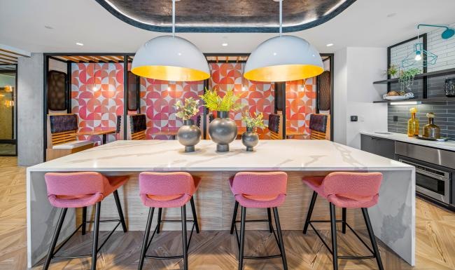 a kitchen island with a table and chairs