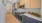 a kitchen with wooden cabinets a stove a fridge and a sink